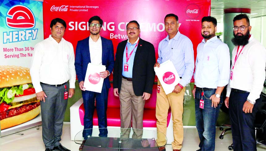 Coca-Cola Company owned bottler International Beverages Private Limited (IBPL) Managing Director Tapas Kumar Mondal and international fast food franchise Herfy's operations Director Imtiaz Faisal, poses for a photograph after signing an agreement at IBPL