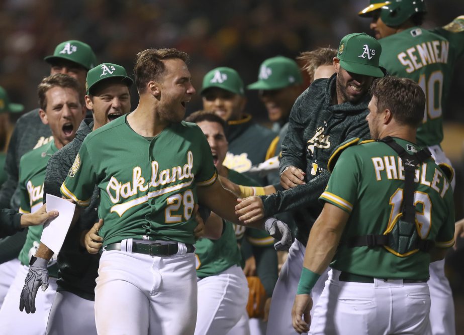 Oakland Athletics' Matt Olson (28) celebrates after hitting the game winning home run off Houston Astros' Tony Sipp in the tenth inning of a baseball game on Friday in Oakland, Calif.