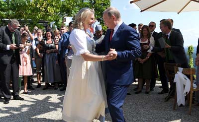 President Vladimir Putin dances with Austria's foreign minister Karin Kneissl at her wedding.