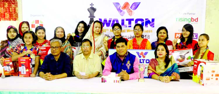 The winners of the Walton 38th National Women's Chess Championship with the guest and the officials of Bangladesh Chess Federation pose for a photo session at Bangladesh Chess Federation hall-room on Sunday.