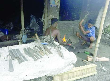 RANINAGAR (Naogaon): Blacksmiths at Raninagar Upazila passing busy time ahead of Eid-ul- Azha . This snap was taken yesterday.