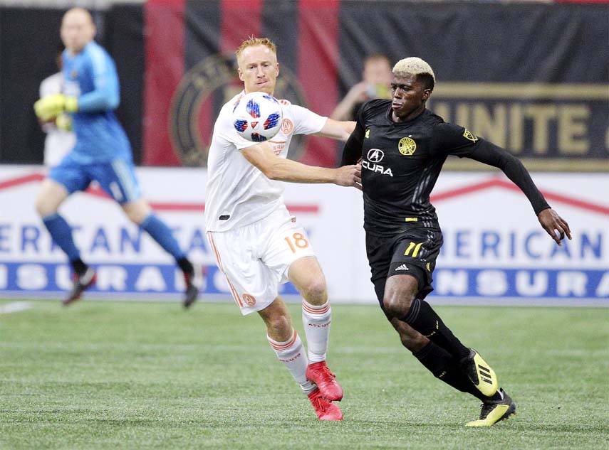 Atlanta United midfielder Jeff Larentowicz and Columbus Crew forward Gyasi Zardes battle for the ball during the second half of an MLS soccer match in Atlanta on Sunday.