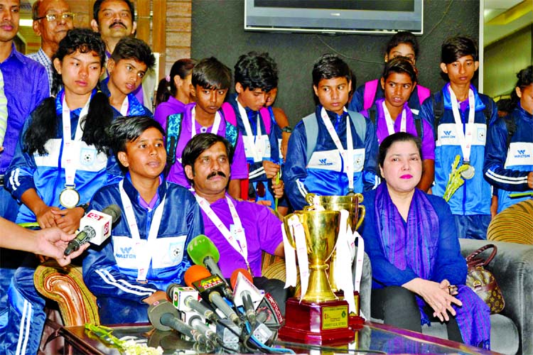 Members of Bangladesh Under-15 National Women's Football team with the BFF officials pose for a photo session at the Hazrat Shahjalal International Airport on Monday.