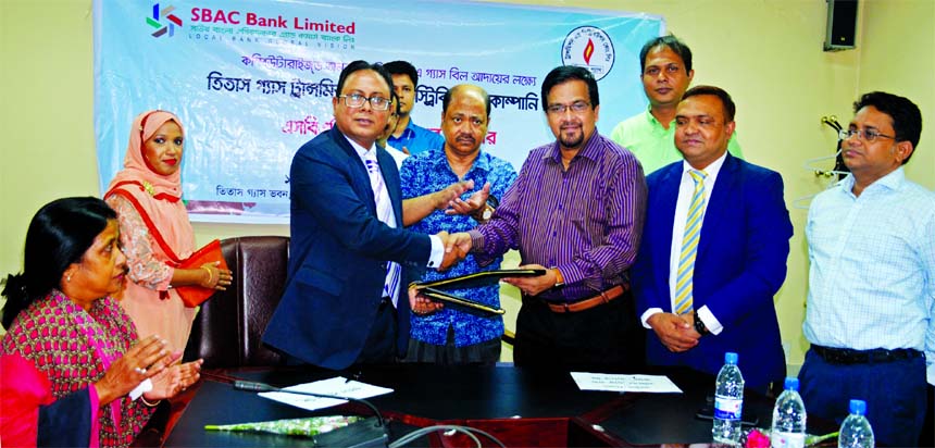 Md. Mamunur Rashid Molla, Deputy Managing Director of South Bangla Agriculture and Commerce Bank Limited (SBAC) and Mahmudur Rab, Company Secretary (Acting) of Titas Gas Transmission & Distribution Company Limited sign an agreement recently. Under this ag