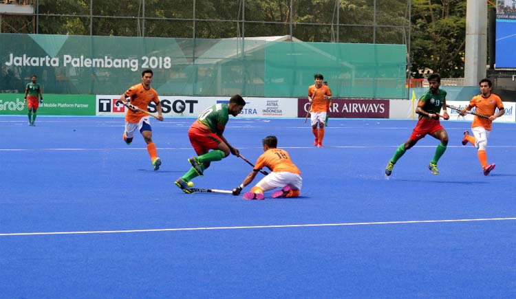 An action from the match of the Asian Games Hockey Competition between Bangladesh Under-23 Hockey team and Malaysia Under-23 Hockey team at Jakarta in Indonesia on Friday.