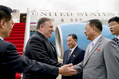 U.S. Secretary of State Mike Pompeo, second from left, is greeted by North Korean Director of the United Front Department Kim Yong Chol, center, and North Korean Foreign Minister Ri Yong Ho, second from right, as he arrives at Sunan International Airport