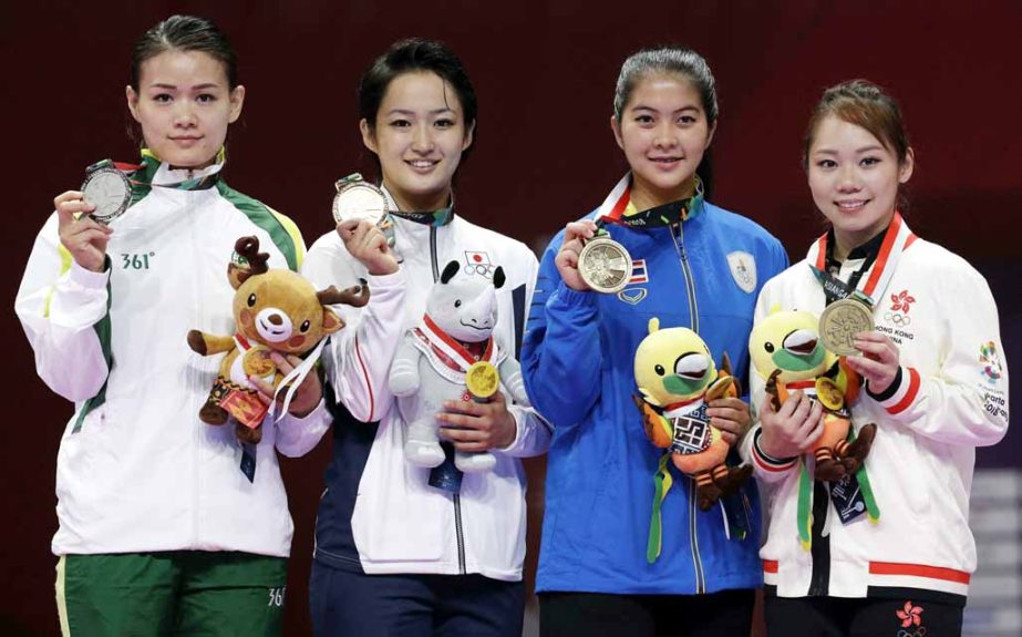 (From left) silver medalist Macau's Soi Lam Sou, gold medalist Japan's Kiyou Shimizu, bronze medalists Thailand's Monsicha Tararattankul and Hongkong's Mo Sheung Lau during ceremonies at the women's kata karate at the 18th Asian Games in Jakarta, Ind