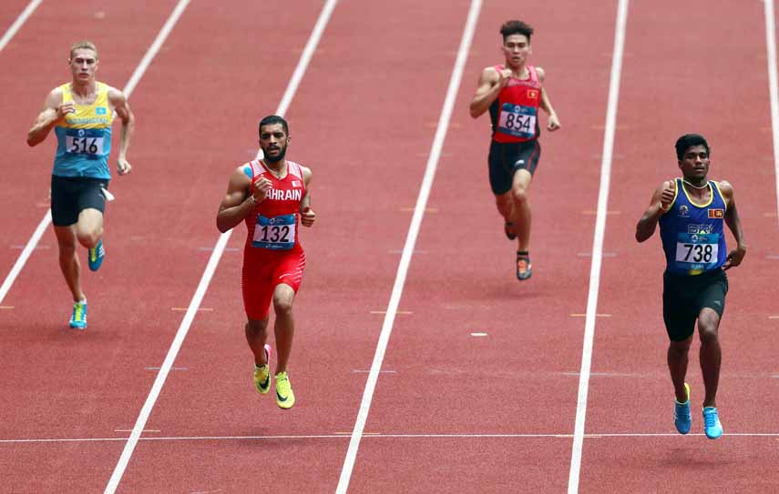 Sri Lanka's Aruna Singhapurage (right) leads the field to the finish line to win his heat of the men's 400m during the athletics competition at the 18th Asian Games in Jakarta, Indonesia on Saturday.