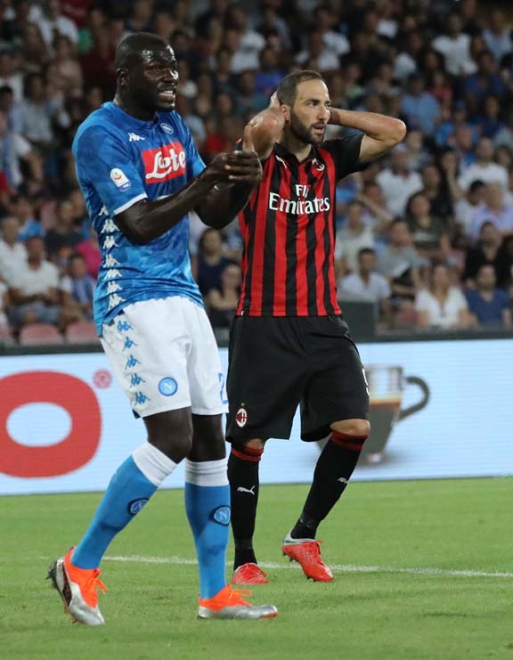 AC Milan's Gonzalo Higuain, right, reacts during the Serie A soccer match between Napoli and AC Milan at the San Paolo stadium in Naples, Italy on Saturday.