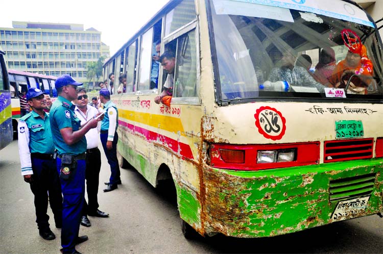 Traffic police examining fitness, route permit documents and driving license of vehicles plying after Eid vacation. The photo was taken from Motijheel area on the first working day of the offices on Sunday.