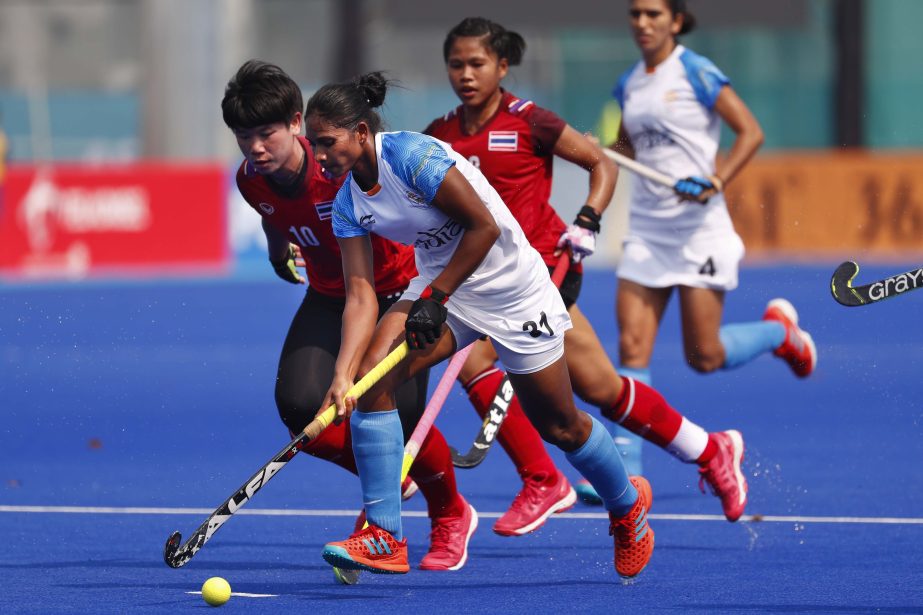 India's Lilima Minz (foreground) runs with the ball during the hockey women's match against Thailand at the 18th Asian Games in Jakarta, Indonesia on Monday.