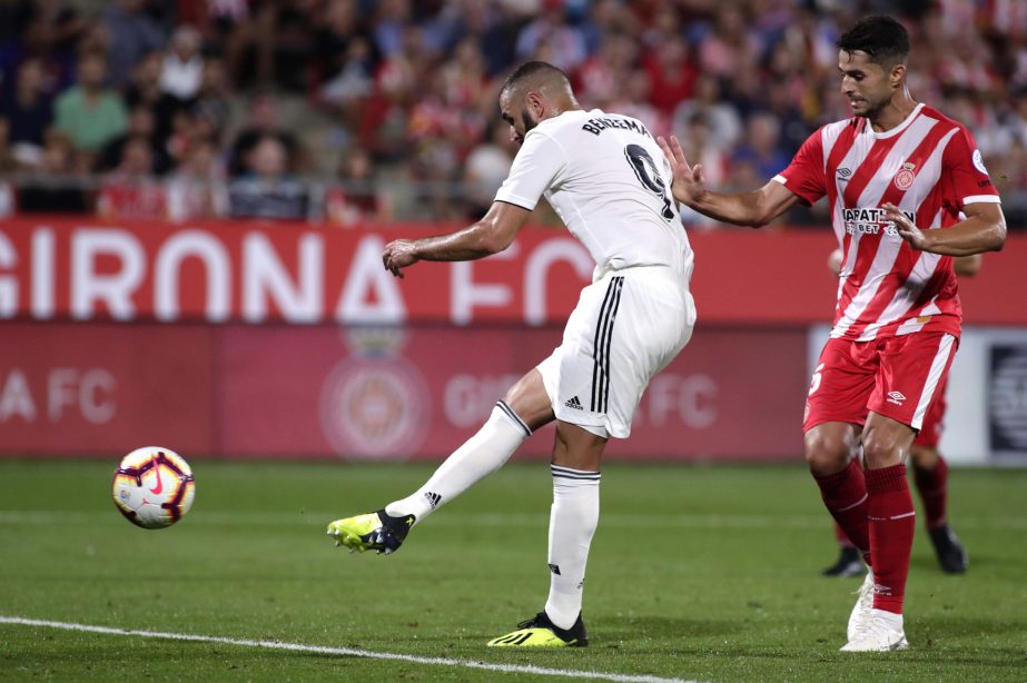 Real Madrid's Karim Benzema scores his side's 4th goal during the Spanish La Liga soccer match between Girona and Real Madrid at the Montilivi stadium in Girona on Sunday.