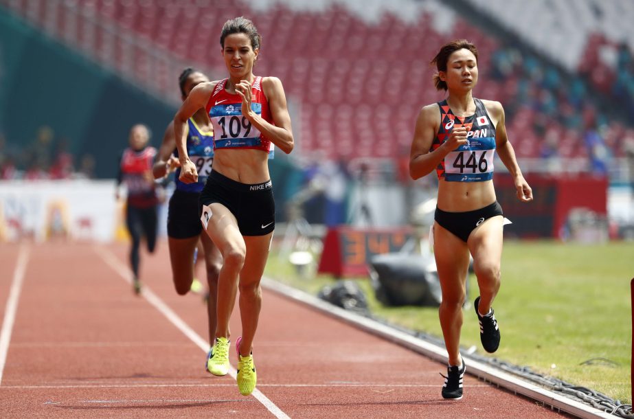 Bahrain's Manai Elbahraoui (left) and Japan's Yume Kitamura race to the finish line in their women's 800m heat during the athletics competition at the 18th Asian Games in Jakarta, Indonesia on Monday.
