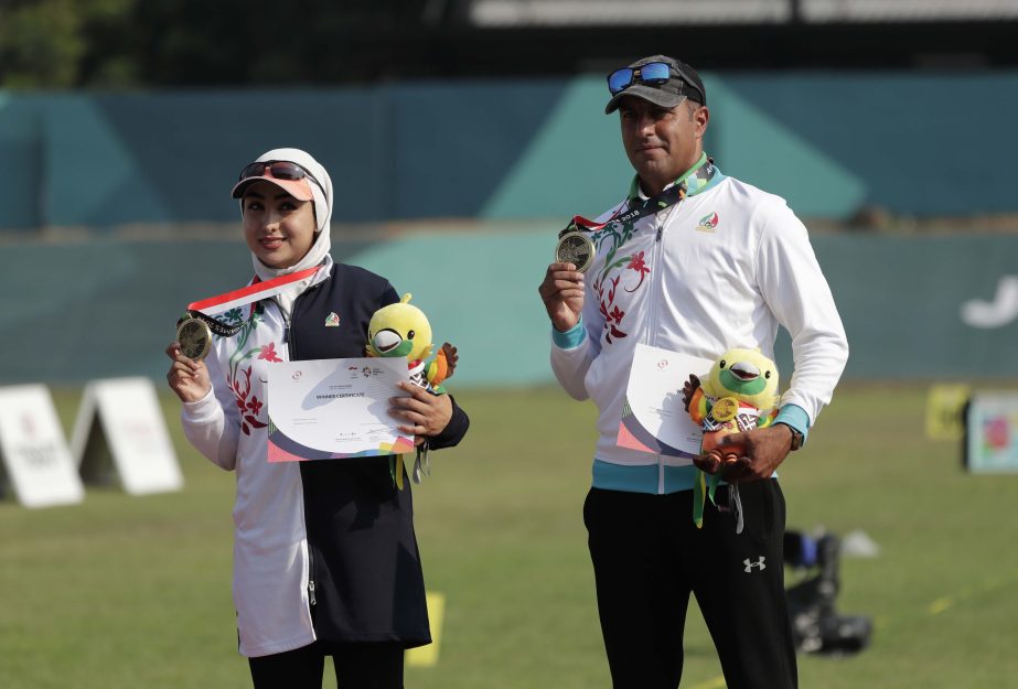 Bronze medalists Fereshteh Ghorbani and Nima Mahboubi Matbooe of Iran hold medals during the award ceremony for the archery compound mixed team match at the 18th Asian Games in Jakarta, Indonesia on Monday.