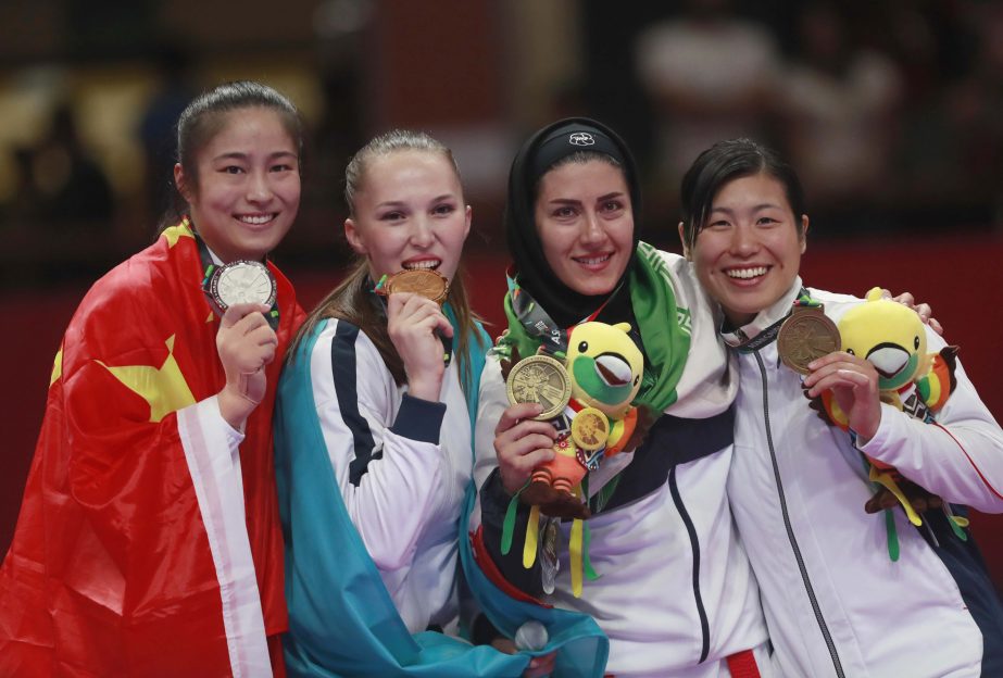 (From left to right): Silver medalist Lingling Tang of China, gold medalist Guzalia Gafurova of Kazakhstan, bronze medalist Pegah Zangenehkarkooti of Iran and bronze medalist Kayo Someya of Japan, pose with their medals during the award ceremony for the w