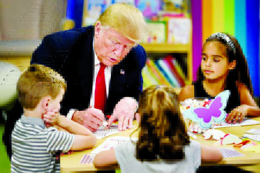 Donald Trump colours in an American flag during a visit to a children's hospital in Ohio but gets it wrong.
