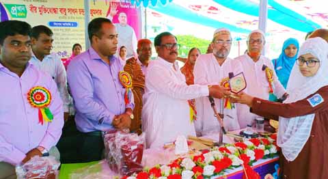 SAPAHAR (Naogaon): Sadhan Chandra Majumder MP distributing crests among the meritorious students as Chief Guest organised by Sapahar Upazila Parishad and Administration on Monday.