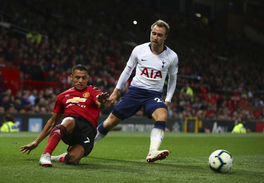 Manchester United's Alexis Sanchez (left) clears the ball from Tottenham Hotspur's Christian Eriksen during the English Premier League soccer match between Manchester United and Tottenham Hotspur at Old Trafford stadium in Manchester, England on Monday.