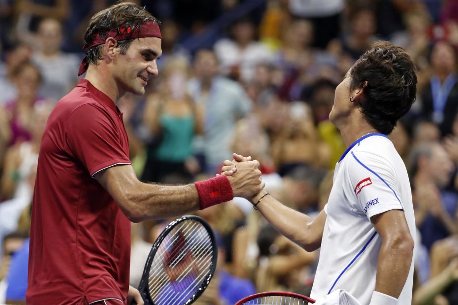Roger Federer of Switzerland (left) shakes hands with Yoshihito Nishioka of Japan, after defeating him during the first round of the US Open tennis tournament on Tuesday.