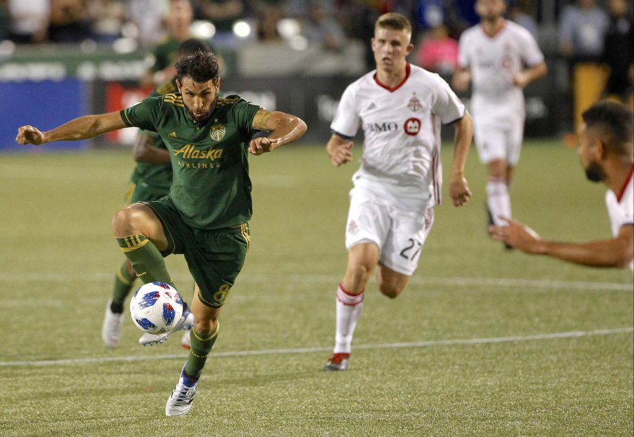 Portland Timbers' Diego Valeri (8) controls the ball next to Toronto FC's Liam Fraser (27) during an MLS soccer match on Wednesday.