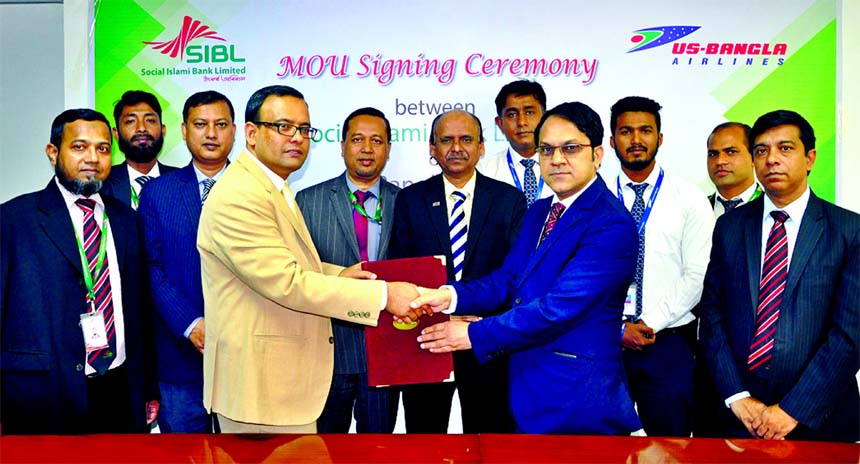 Zabed Amin, Head of Card Division of Social Islami Bank Limited, Md. Shafiqul Islam, Head of Marketing & Seles of US-Bangla Airlines, exchanging an agreement signing documents at the Bank's head office in the city on Thursday. Under the deal, Islamic Cre