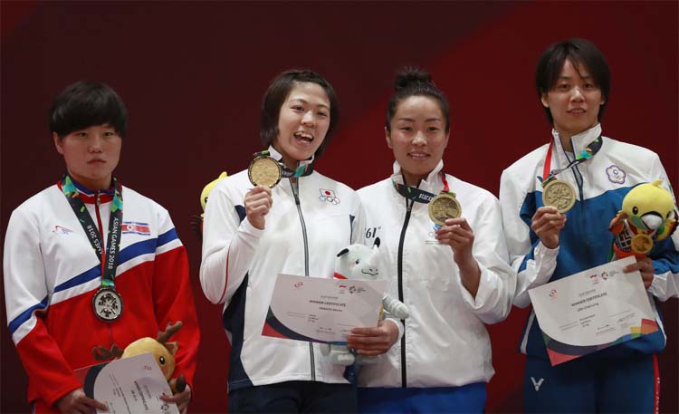 From left to right, silver medalist Kim Jin A of North Korea, gold medalist Momo Tamaoki of Japan bronze medalist Sumiya Dorjsuren of Mongolia and bronze medalist Lien Chen Ling of Taiwan with their medals as they pose for photographers during the victory