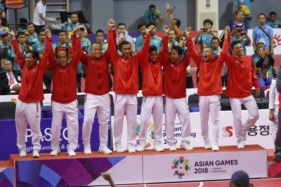 Indonesia's team celebrate during awards ceremony after match against Japan team during the men's quadrant gold medal match at the 18th Asian Games in Palembang, Indonesia on Saturday.