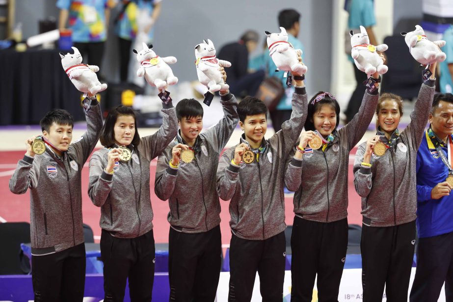 Gold medalist Thailand's women sepak takraw team show their medal during award ceremony for the women's quadrant final at the 18th Asian Games in Palembang, Indonesia on Saturday.