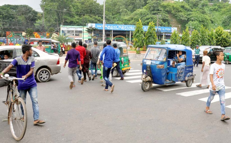 Passers-by randomly violated traffic rules in the Port City . This picture was taken from Tiger Pass area yesterday.