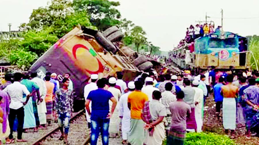 A passenger bus overturned after being hit by a running train while crossing an unmanned Railway Gate at Mirersarai in Chattogram on Sunday leaving two killed and 23 others injured.