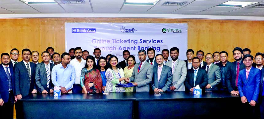 Md. Arfan Ali, Managing Director of Bank Asia Limited and Maliha M Quadir, Founder and Managing Director of Shohoz.com, exchanging a MoU signing documents on providing online ticketing services to mass community through the Bank's Agent Banking network a
