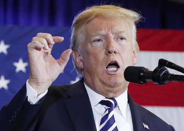 US President Donald Trump speaks with reporters upon arriving at the White House