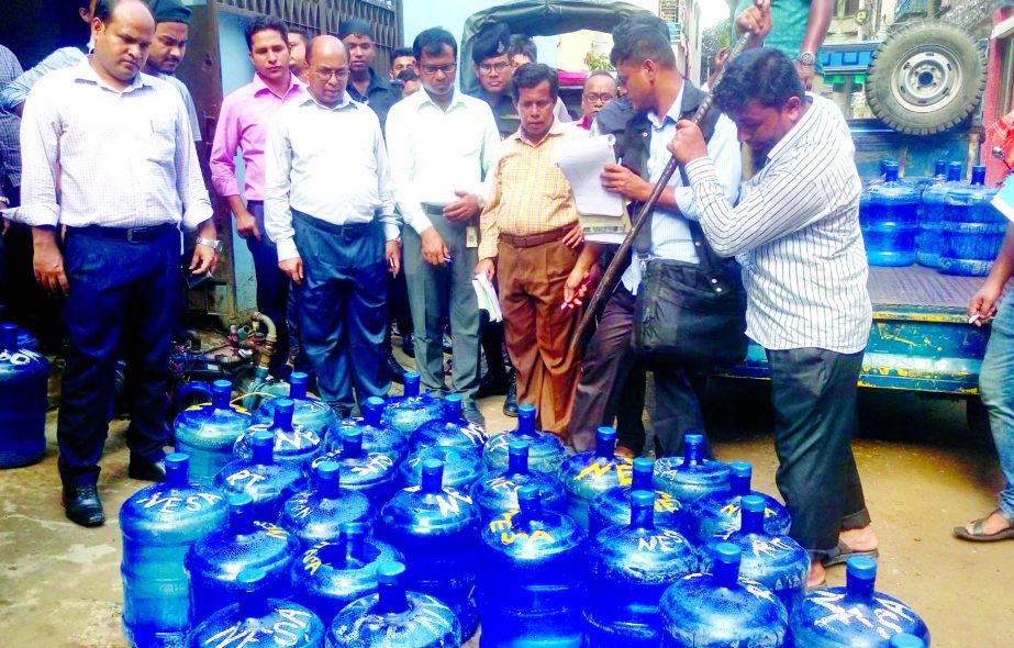 Dhaka WASA mobile court dismantling the jars with contaminated water and for not using the BSTI logo. This picture was taken from city's Mirpur area on Tuesday.