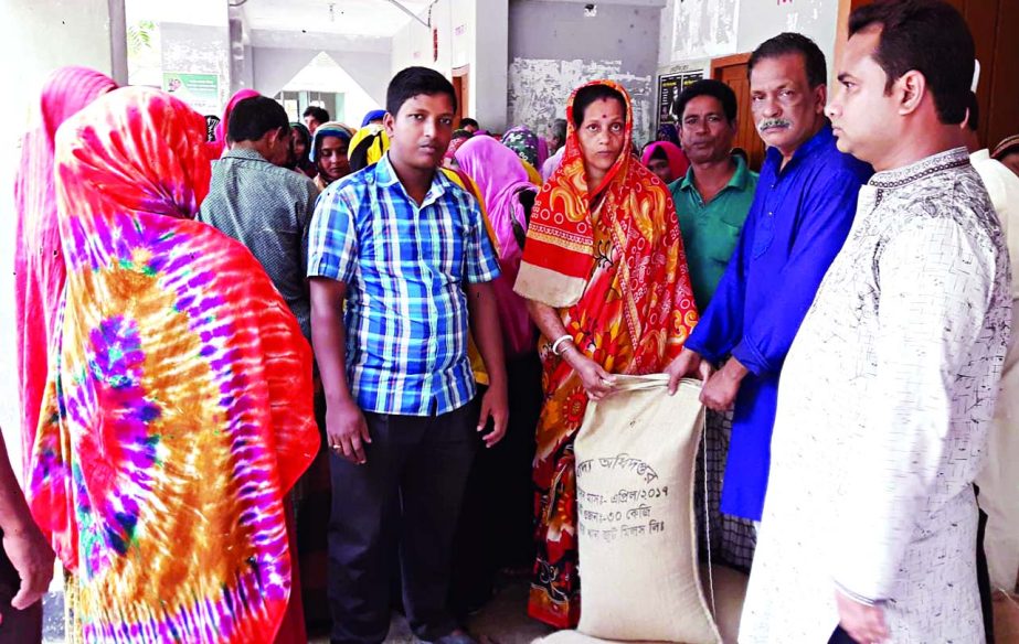 BANARIPARA (Barishal): Khijir Sarkar, Chairman, Chakhar Upazila Parishad distributing VGD rice among the poor people of the area recently.