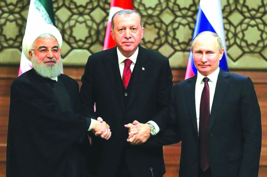 Iran's President Hassan Rouhani, Turkey's President Recep Tayyip Erdogan and Russia's President Vladimir Putin shake hands after a joint press conference as part of a tripartite summit on Syria, in Ankara.