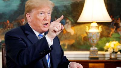 US President Donald Trump speaks to reporters after signing a proclamation declaring his intention to withdraw from the JCPOA Iran nuclear agreement in the Diplomatic Room at the White House in Washington.