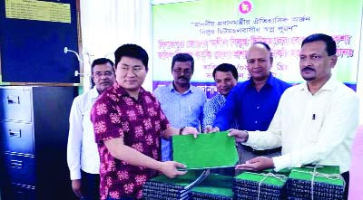 DINAJPUR: Subal Chakma, Executive Magistrate of Panchagarh receiving land record and map documents for the former enclaves on behalf of the Panchagarh District Administration from Dinajpur Zonal Settlement Officer Shamsul Azam at a function held in D