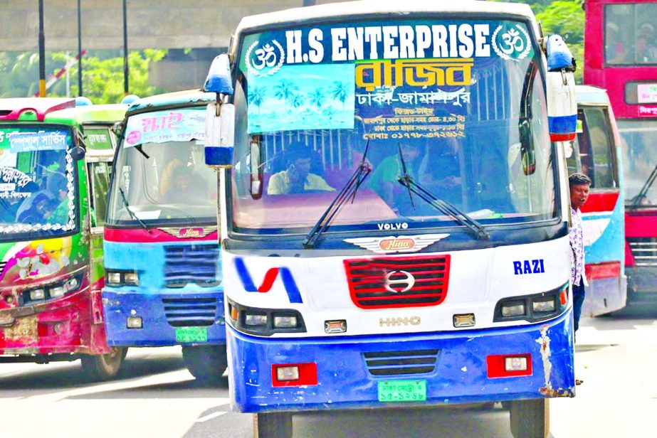 Three passenger buses on the streets competing each other to move faster for fetching passengers despite cries for safe roads by different quarters beside stringent security steps taken by the traffic authorities. Photo also shows a driver engaged in talk