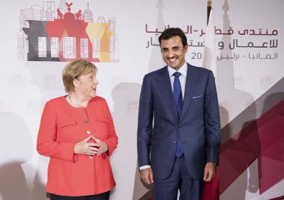 German Chancellor Angela Merkel, left, and the Emir of Qatar Tamim bin Hamad Al Thani, right, pose for a photo prior to the 'Qatar - Germany Forum For Business And Investment' in Berlin on Friday.