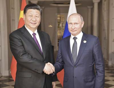 China's President Xi Jinping, left, poses with Russia's President Vladimir Putin for a photo at the BRICS summit in Johannesburg on Friday.