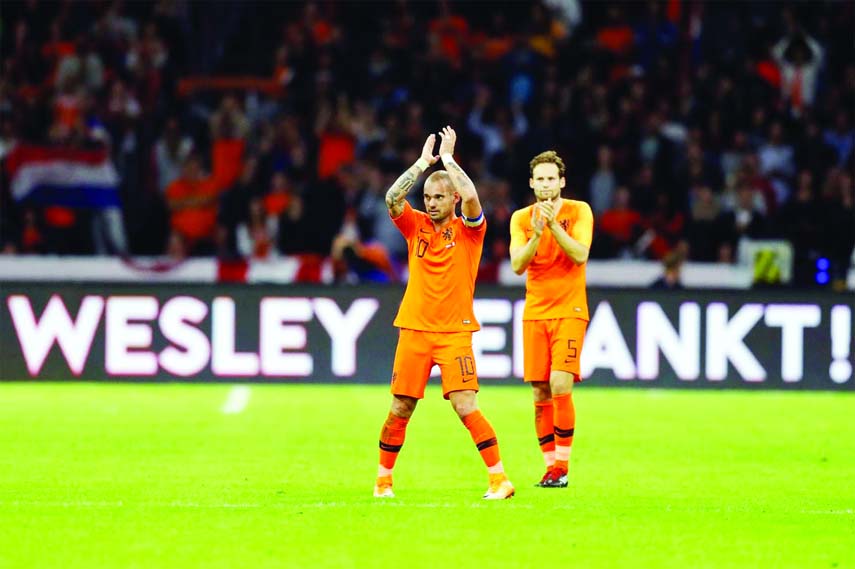 A billboard reads "Wesley Thank You" as Wesley Sneijder of The Netherlands acknowledges the applause after he was substituted during the international friendly soccer match between The Netherlands and Peru at the Johan Cruijff Arena in Amsterdam, Nether
