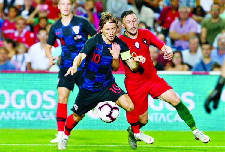 Croatia's Luka Modric fights for the ball with Portugal's Mario Rui (right) during the international friendly soccer match between Portugal and Croatia at the Algarve stadium, outside Faro, Portugal on Thursday.