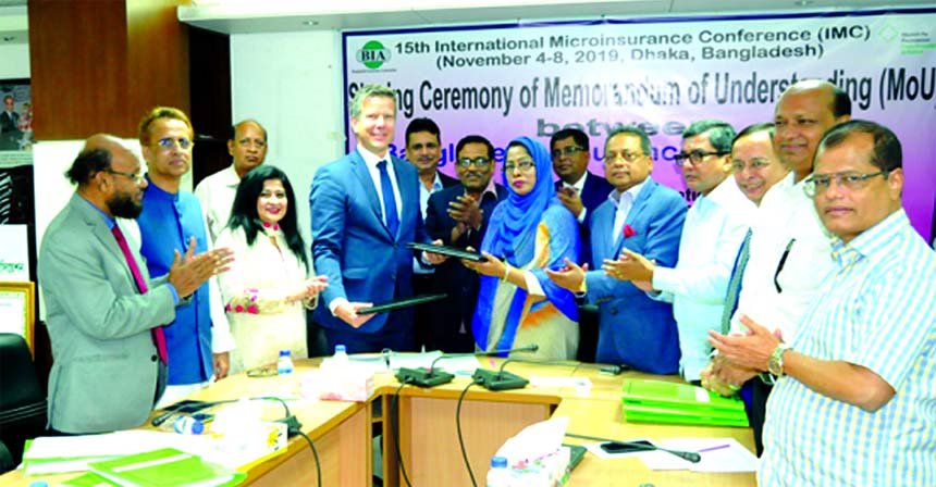Professor Dr. Rubina Hamid, First Vice-President of Bangladesh Insurance Association (BIA) and Dirk Reinhard, Vice-Chairman of Munich Re Foundation (a German based NGO), exchanging a MoU signing document will be held at the 15th International Micro Insura
