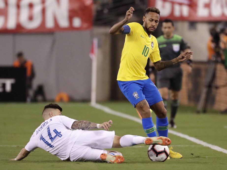 Brazil forward Neymar (right) tries to avoid slide tackle from United States midfielder Paul Arriola during the second half of an international soccer friendly match in East Rutherford, N.J. on Friday.