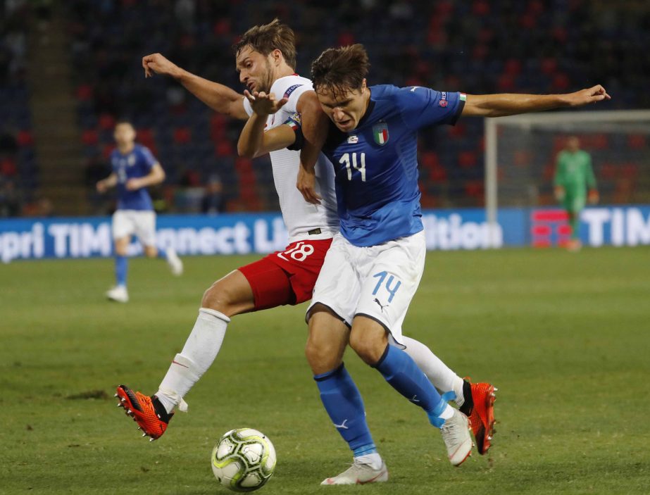 Italy's Federico Chiesa and Poland's Bartosz Bereszynski (left) vie for the ball during the UEFA Nations League soccer match between Italy and Poland at Dall'Ara stadium in Bologna, Italy on Friday.