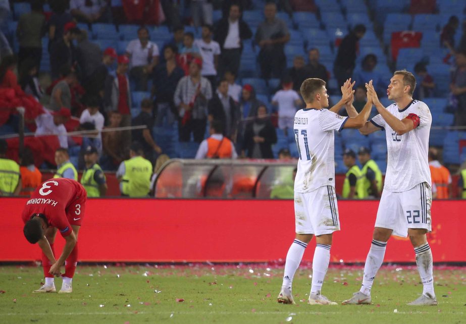 Russia's Artem Dzyuba (right) celebrates with his teammate Roman Zobnin, following the UEFA Nations League soccer match between Turkey and Russia in Trabzon, Turkey on Friday. Russia won the match 2-1.