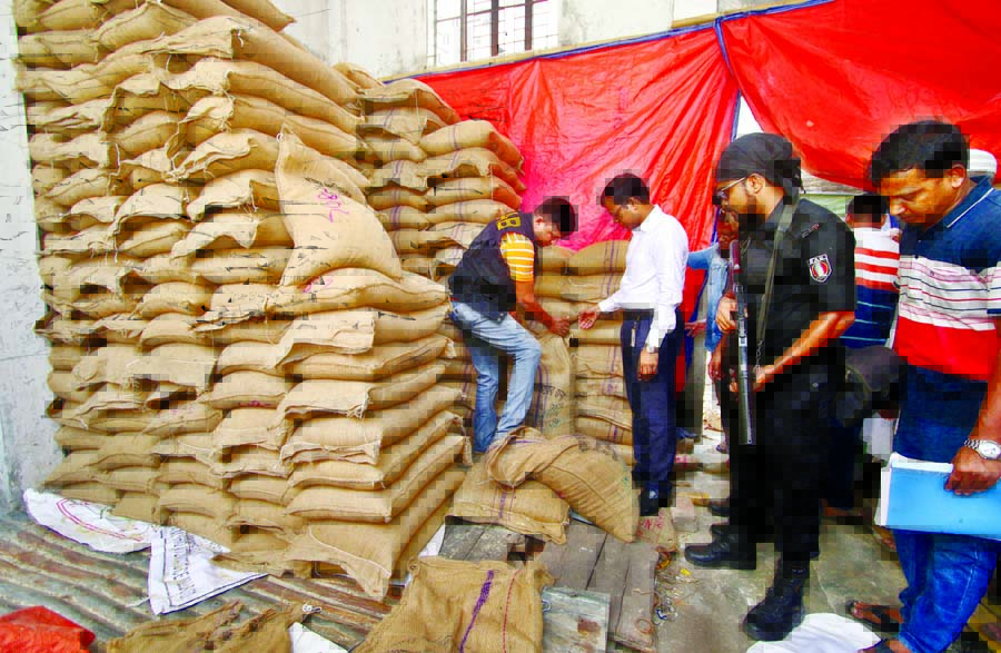 RAB team seized 215 tonnes of OMS rice and wheat from govt silo in Tejgaon and Krishi Market of Mohammadpur in separate drives. The photo was taken on Sunday.