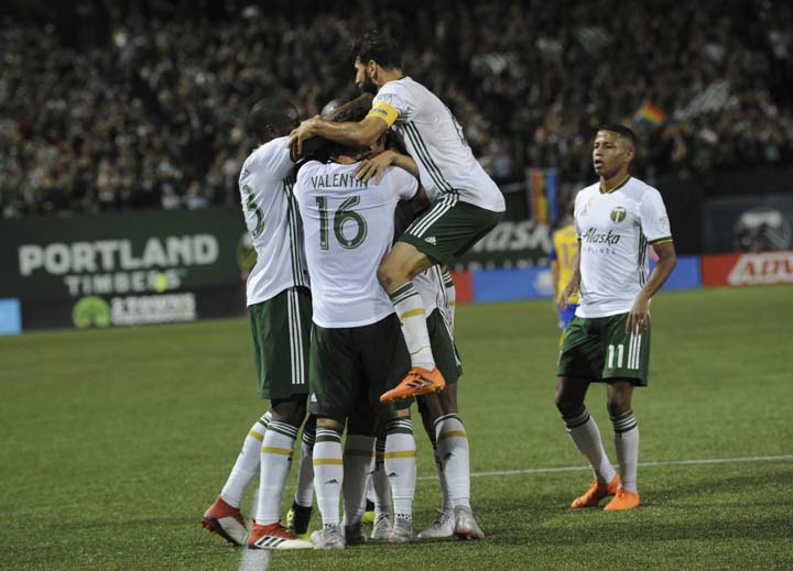 Portland Timbers celebrate a goal by Jeremy Ebobisse during the first half of an MLS soccer match against the Colorado Rapids in Portland, Ore on Saturday.