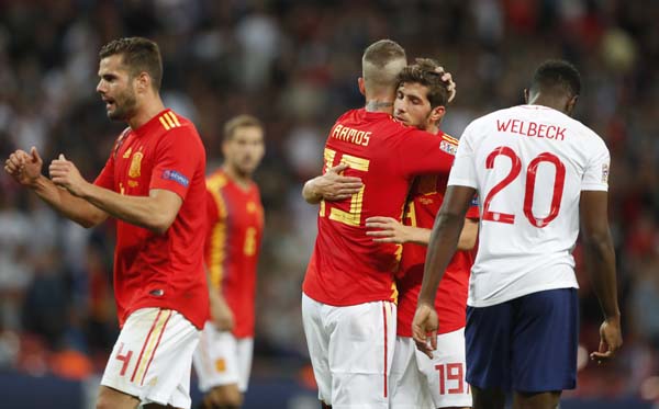 Spain's Sergio Ramos (center) hugs teammate Sergi Roberto as England's Danny Welbeck (right) walks by at the end of the UEFA Nations League soccer match between England and Spain at Wembley stadium in London. Spain won 2-1 on Saturday.