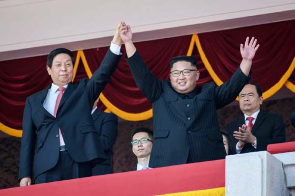 Politburo Standing Committee member Li Zhanshu (L) met North Korea's leader Kim Jong Un Â® during a military parade and mass rally to mark the 70th anniversary of the founding of North Korea.